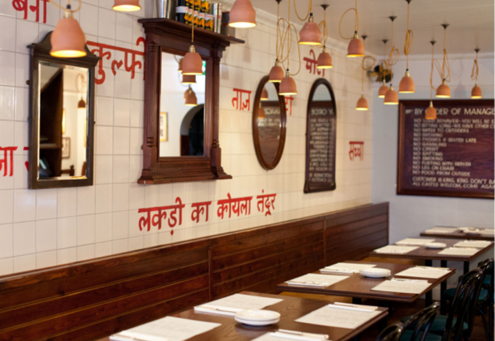 The interior of a restaurant with Indian decor.