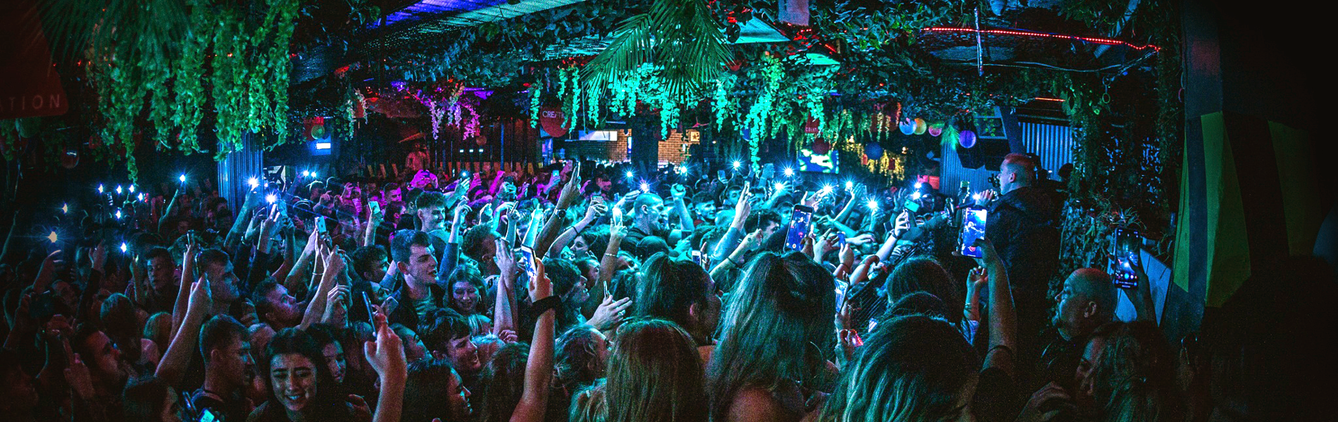 People dancing in a crowded nightclub.