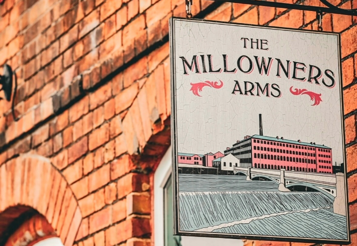 The sign hanging outside The Millowners Arms.