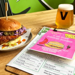 A burger and a glass of beer on a table at Vocation & Co