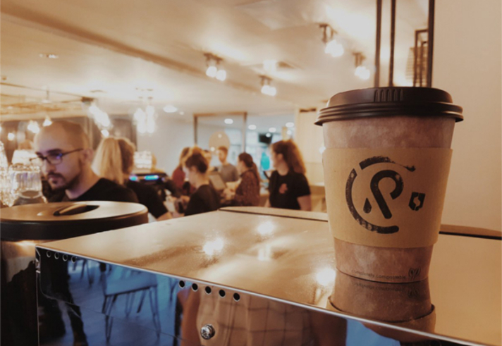 The interior of Coffee Revolution, featuring one of their disposable coffee cups.