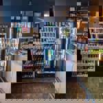 Shelves and fridges full of bottles and cans of beer.