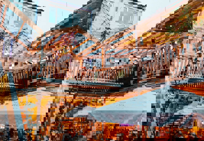 The courtyard at Hagglers Corner, filled with tables and chairs. You can also see the balcony that runs around the second floor.