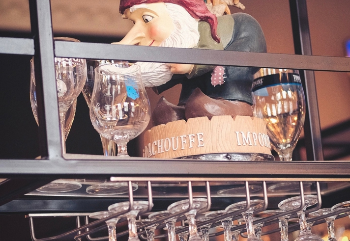 A model of a pirate hiding on am overhead glass rack, above the bar.