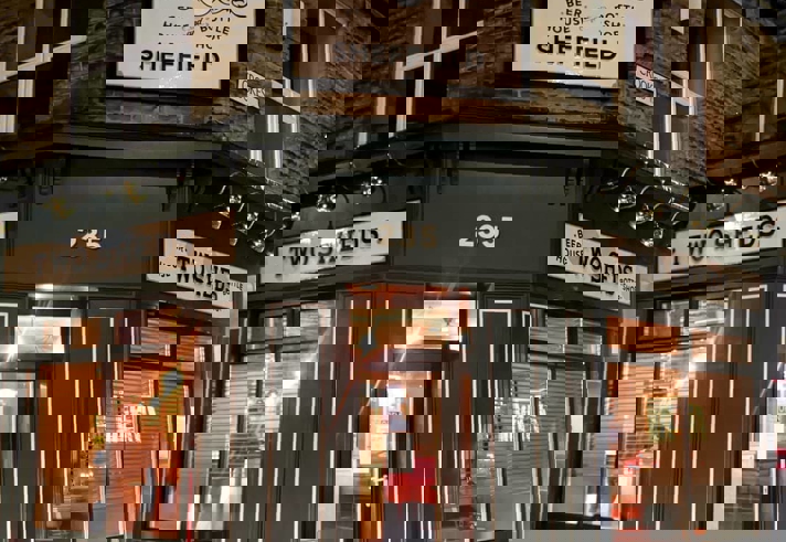 The exterior of the Two Sheds at night.