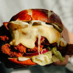 A cheese burger being carried by a member of staff at the Two Thirds Beer Co.