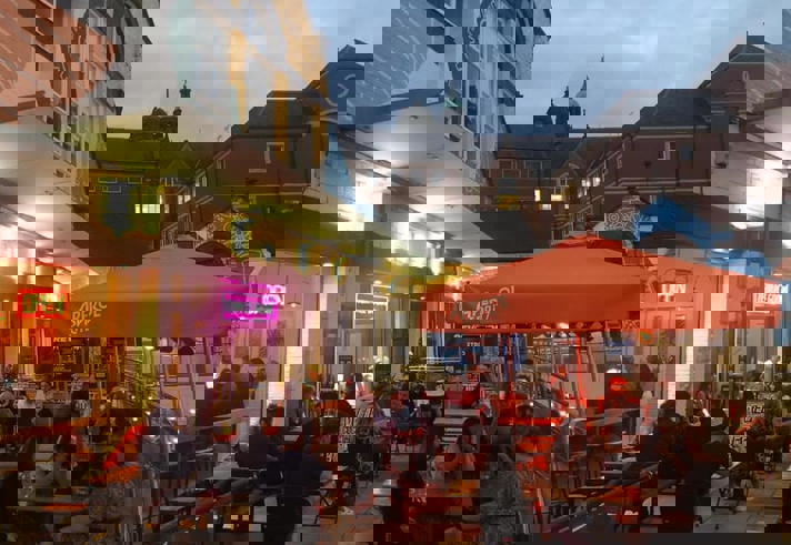 People dining outside at Terrace Goods, in the evening.